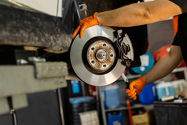 istock Mechanic working on car brake disc in auto workshop 2248842822