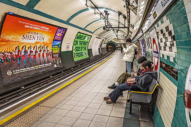 Russel Square Station, London, England, UK, November 14, 2025: Classic scene with waiting passengers relaxing on benches as they wait for their underground train at Russell Square station in central London.