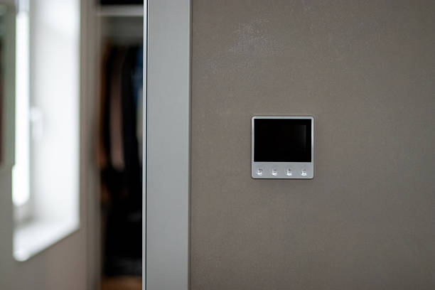 istock Close up of a modern thermostat control system on a beige wall 2248847327