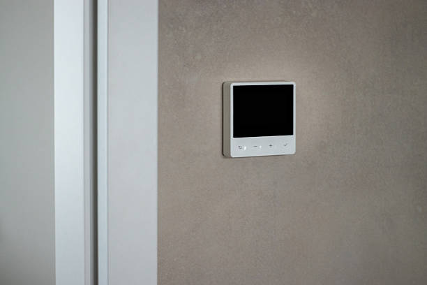 istock Close up of a modern thermostat control system on a beige wall 2248847355