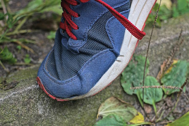 A vibrant close-up of a red shoelace, adding a bold statement to footwear with its striking color.