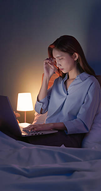 istock businesswoman use notebook work overtime on bed 2248850307