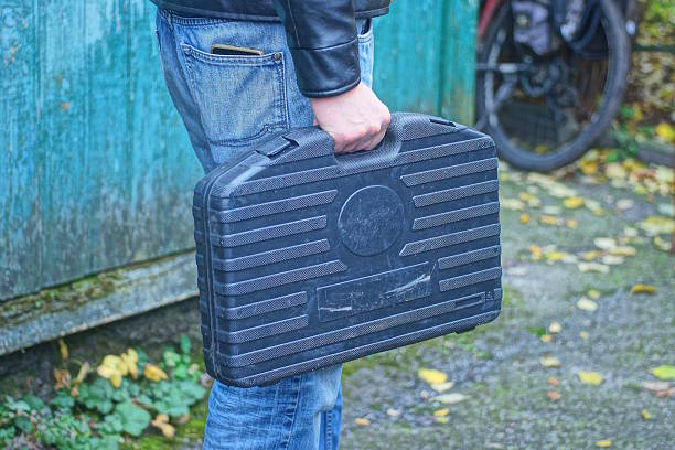 istock A man holds a large black plastic toolbox in his hand 2248850980