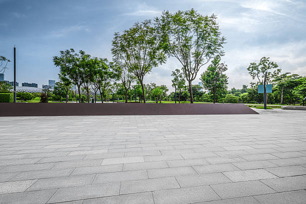 istock Empty square floor and green trees with blue sky clouds background in the city. 2248852164