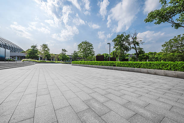 istock Empty square floor and modern building with green plants. 2248852196