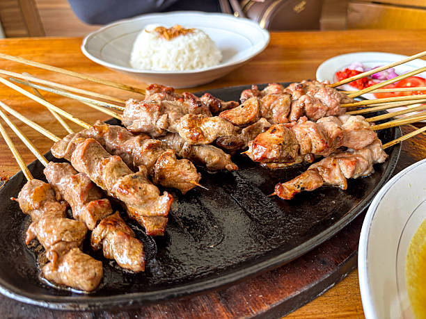istock Delicious grilled satay skewers presented with white rice on a dark plate, inviting culinary 2248852317