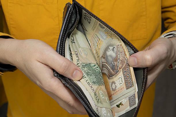 istock Hands holding an open wallet filled with Polish banknotes. Close up image symbolizing cash 2248852884