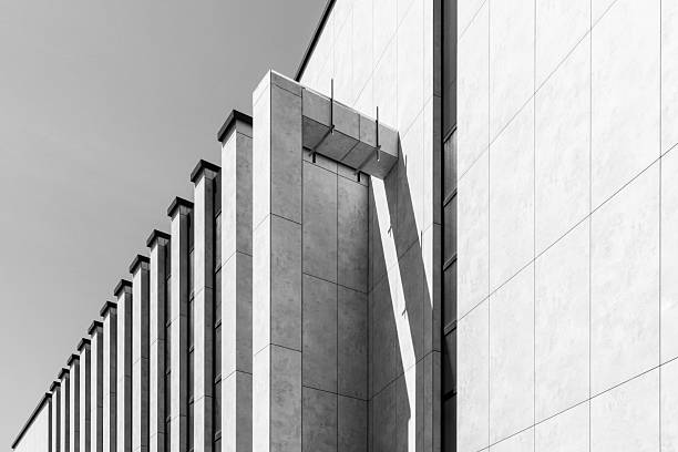 istock Modern Geometric Building Facade With Concrete Columns In Harsh Sunlight Minimalist Black And White Architecture Background 2248853103