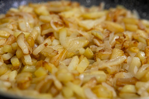 istock Sliced potatoes with onions are deliciously fried in a frying pan. 2248853607