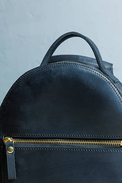 istock Women's leather black backpack on the shoulder. Handmade leather backpack. 2248854597