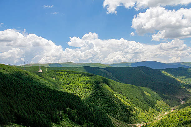 istock Beautiful green mountain range under a blue sky with white clouds 2248857486