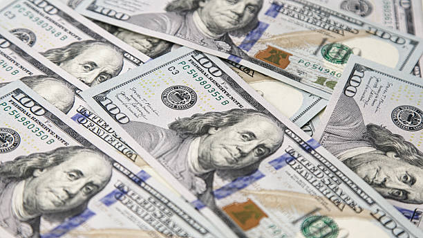 istock Close-up view of multiple hundred-dollar bills stacked together 2248858065