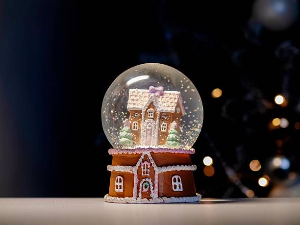 istock Delicate snow globe featuring holiday sweets and glowing lights 2248858540