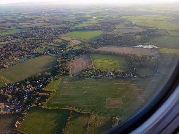 Stansted, London, England, December 30, 2024. View from the plane just after takeoff from Stansted Airport, located in Essex, about halfway between London and Cambridge. You can see cultivated fields, wooded areas, and small settlements, a typical English countryside landscape.