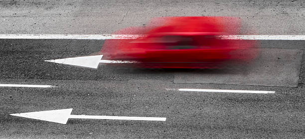Car wake, swept, red car driving on a city road