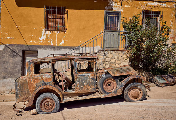 Old car with rust abandoned on the street