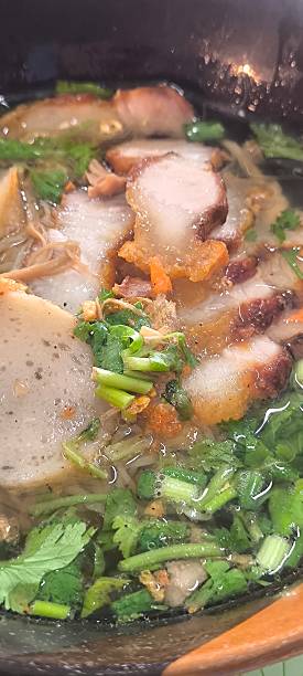 istock Noodle soup in a ceramic bowl on a wooden table 2248865883