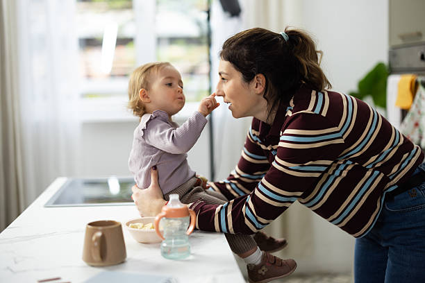 istock Mother and baby daughter playful bonding in kitchen 2248865991