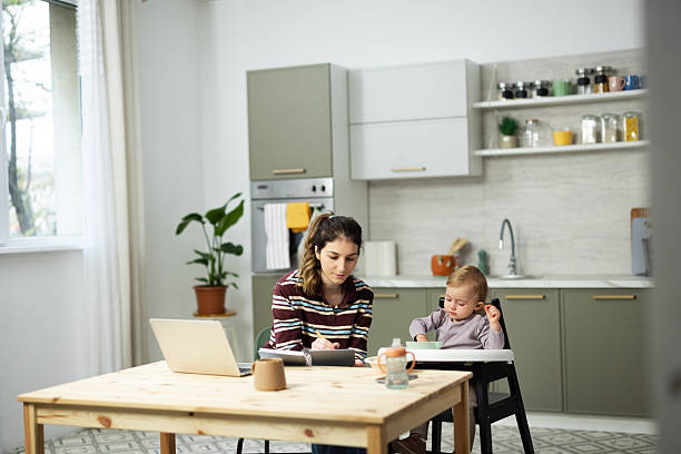 istock Mother working from home while baby is eating in high chair 2248866031