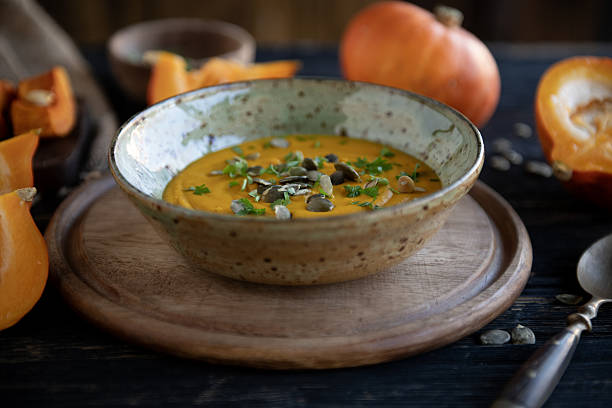 istock Pumpkin Soup in Rustic Bowl with Wooden Background – Fall Culinary Still Life 2248866880