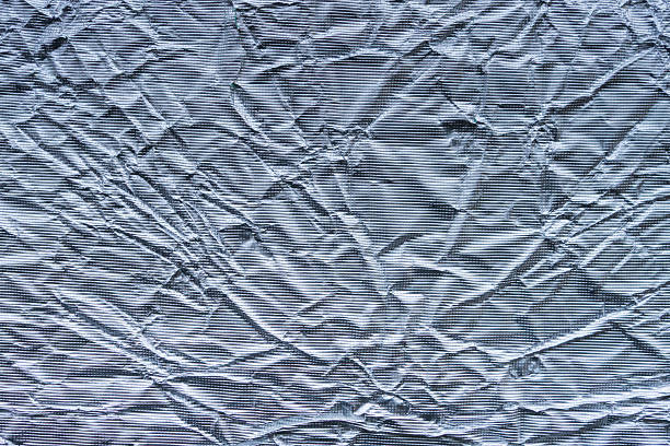 Shiny metal silver gray foil leaf crumpled texture background