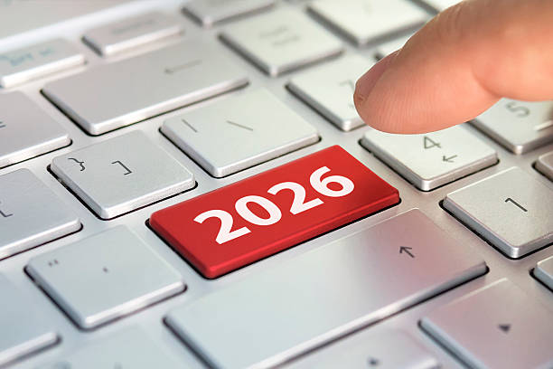 istock Keyboard with text 2026 year and finger pushing the enter button. Color button on the gray silver keyboard of modern ultrabook. caption on the button 2248869400