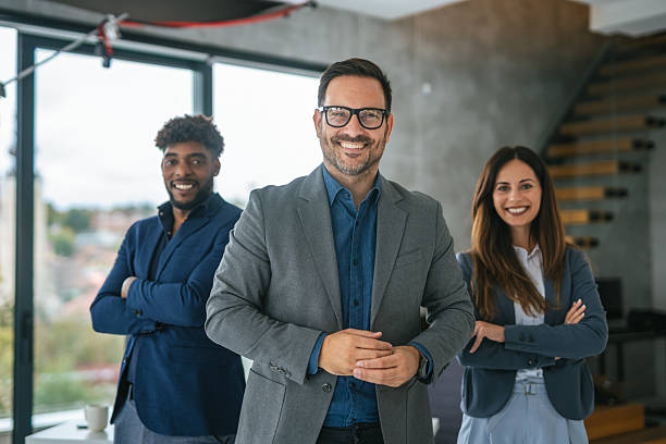 istock Diverse business team partners standing confidently in modern office 2248870554