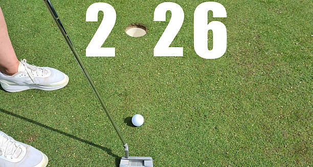istock Golfer with 2026 golf ball at hole on golf course 2248871357