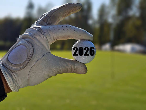 istock Countdown to 2026 marked on golf ball held in hand against green field backdrop concept 2248871364