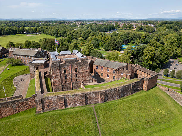 CARLISLE, CUMBERLAND ENGLAND - JUNE 18, 2025: Aerial view of Carlisle Castle with a flag on the central tower, Cumbria