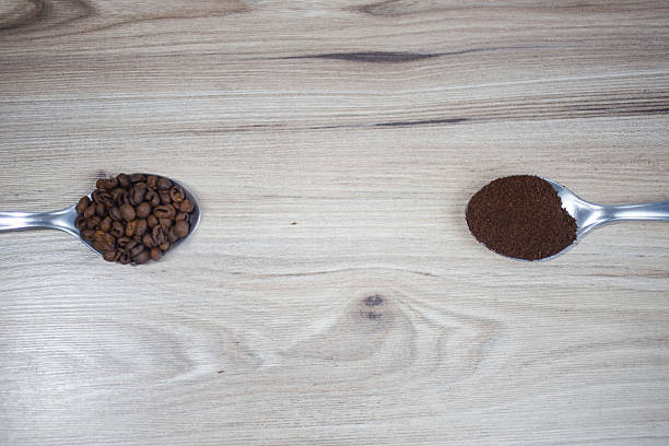 Spoons with Coffee Beans and Ground Coffee Side by Side
