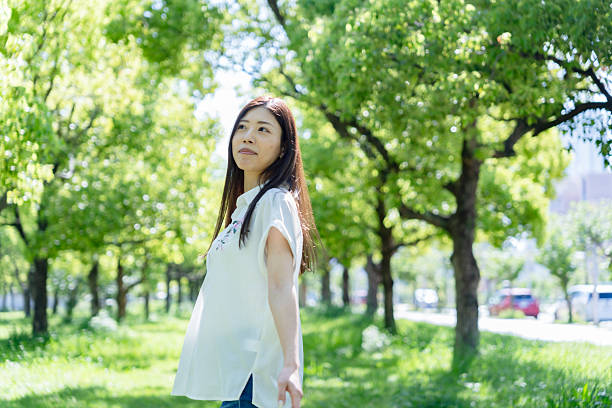 istock Happy Woman Running Through a Sunny Green Park 2248875928