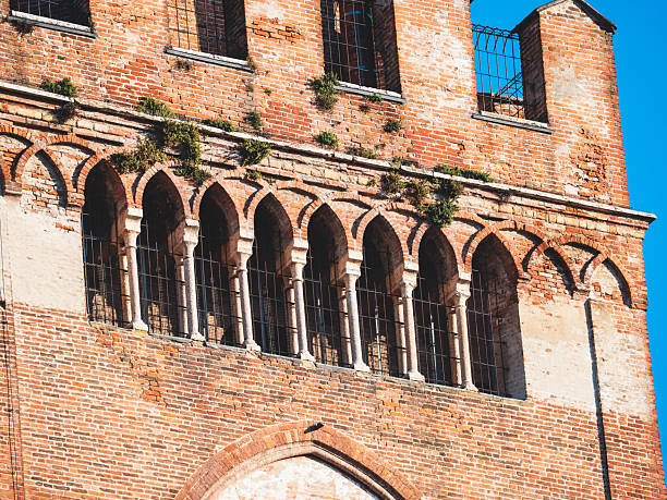 Cremona, Italy - October 3rd 2025 Torrazzo bell tower in Cremona, Italy, showcasing intricate Gothic arches, ancient brickwork, and timeless architectural details