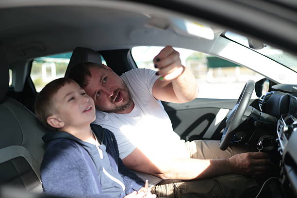 istock Father and son sharing happy moment in car 2248883682