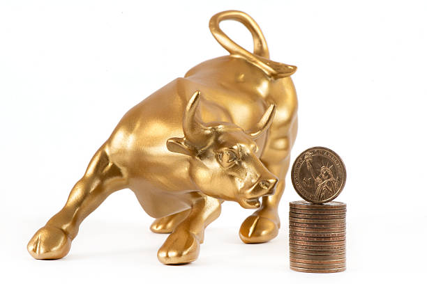 istock US $1 coin and a golden bull on a white background 2248883890