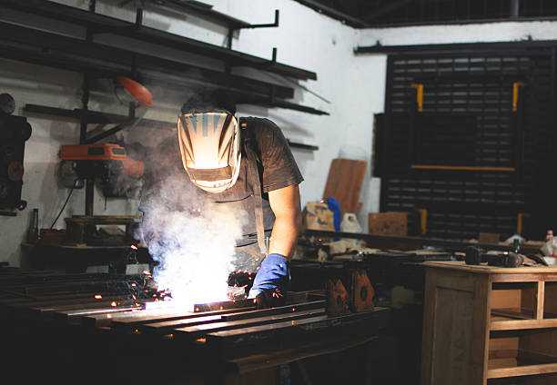 istock Deaf man using a welding torch in the workshop. Professional welder working at the workbench 2248884095