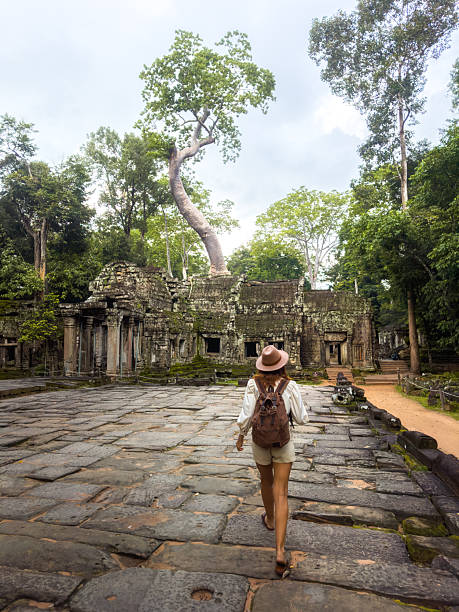 istock Traveler Exploring Ta Prohm Temple Ruins With Giant Tree In Cambodia 2248885025
