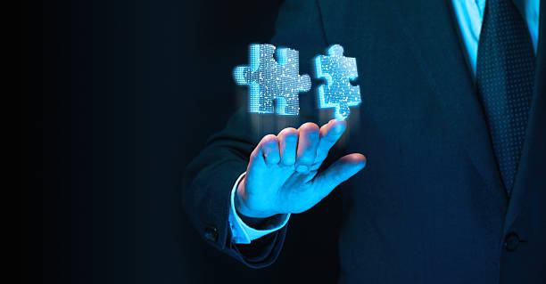 istock Businessman hand with glowing holographic puzzle pieces 2248887233