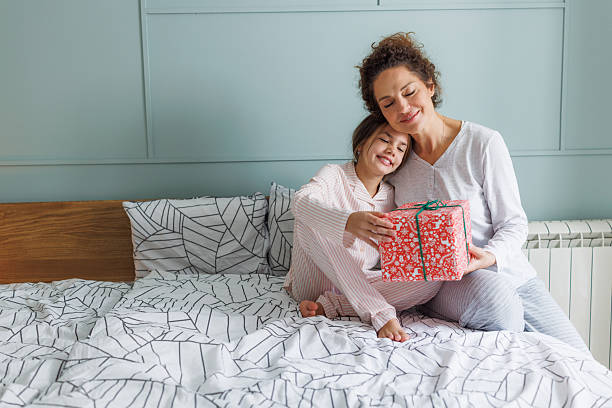 istock A woman surprising her daughter with a gift 2248887245