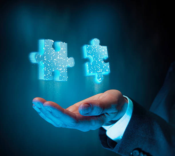 istock Businessman hand with glowing holographic puzzle pieces 2248887426