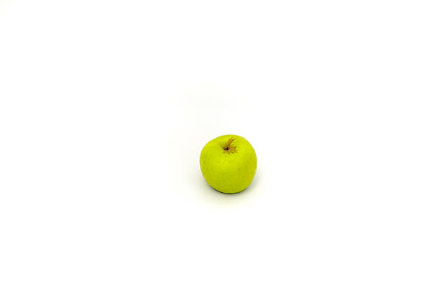 A single green apple isolated on a white background shows healthy eating concept
