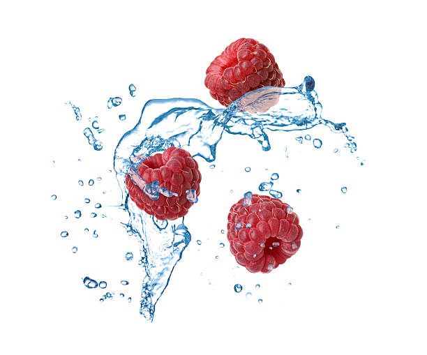 istock Fresh ripe raspberries and water splash in air on white background 2248890725