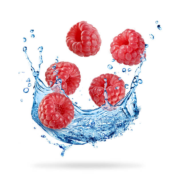 istock Fresh ripe raspberries and water splash in air on white background 2248890738