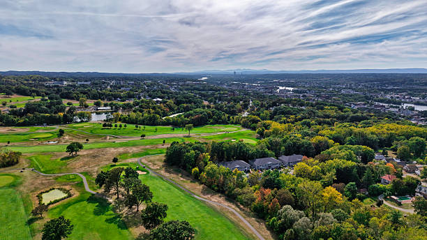 istock Golf course meanders through a New England landscape towards a distant city during the daytime 2248891733