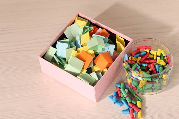 istock Color paper pieces on light wooden table, above view 2248892499