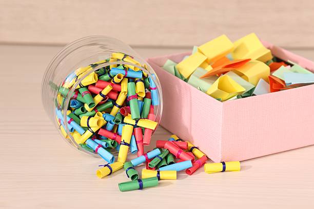 istock Color paper pieces on light wooden table, closeup 2248892501
