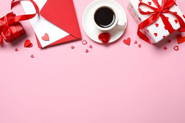 istock Festive composition with cup of coffee with gift box, envelope and hearts on color background 2248894315