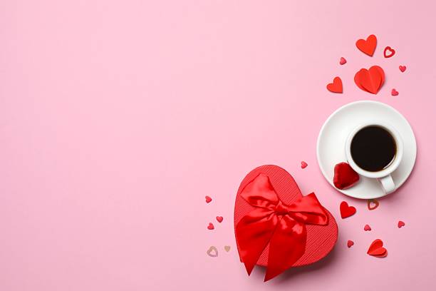 istock Flat lay with red hearts, gift box with cup of coffee on color background 2248894317