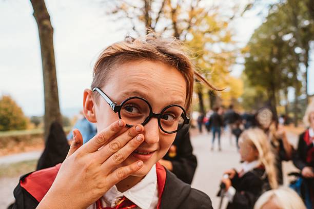 Child Dressed as Wizard Smiling in Park Gathering