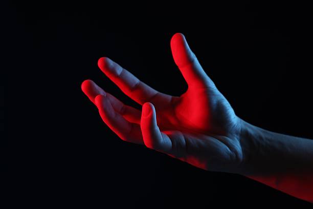 Man holding something on black background, closeup